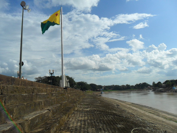 Rio Acre e bandeira do Estado, que possui duas partes, uma amarela que representa a paz e outra verde que representa a esperança. A estrela vermelha no canto superior esquerdo, chamada de