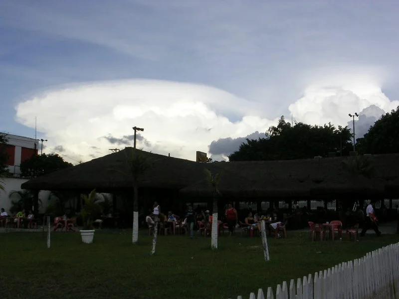 Devido à iluminação, a nuvem de chuva (cumulonimbus) está branca e a nuvem que não gera chuva (cumulus, ao lado) está cinza - para quem está embaixo da cumulonimbus, o céu todo aparece cinzento e coberto pela nuvem. Foto: ViniRoger