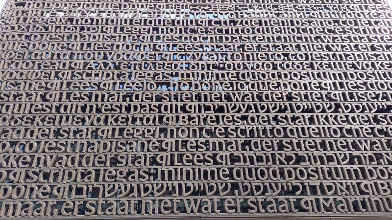 Arte textual da fachada da Biblioteca da Universidade de Amsterdã, na Holanda, composta por letras tridimensionais metálicas em vários idiomas. Foto: ViniRoger